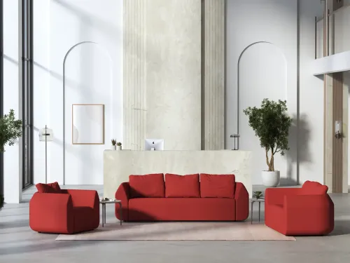 Ark kırmızı koltuk ve kanepe takımı, kavisli formu ve güçlü hacmiyle modern lobi, resepsiyon ve yönetici bekleme alanlarında heykelsi bir karşılama atmosferi oluşturur.